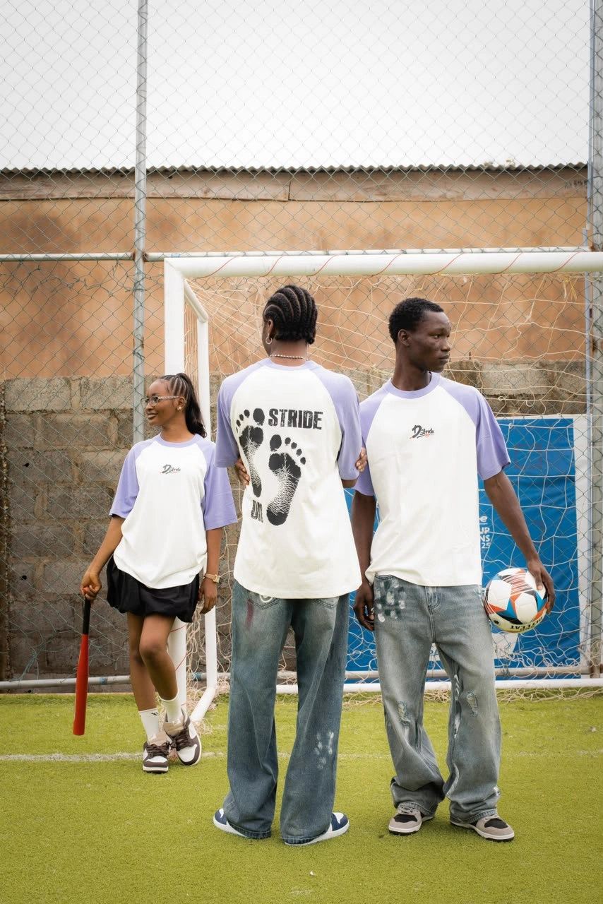 Three models with d'stride outfits on a soccer scenery
